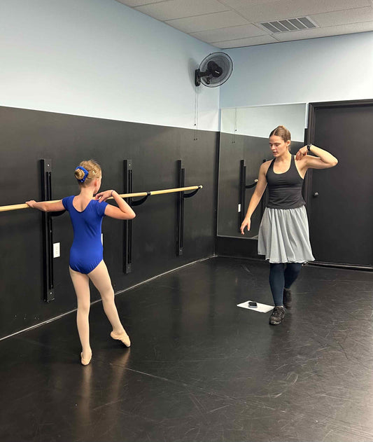 9 year-old ballet student at the barre being corrected by Hayden Creech